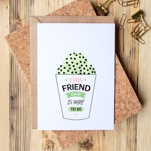 May include: A white greeting card with a mint green ice cream design and the text "This Friend Chip Is Mint To Be". The card is on a corkboard with a brown envelope and gold paper clips.