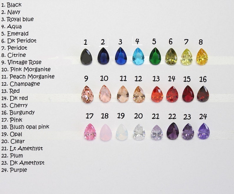 May include: A color chart featuring 24 teardrop-shaped gemstones in various colors, including black, navy, royal blue, aqua, emerald, peridot, citrine, and pink. Each gem is labeled with its corresponding color name.
