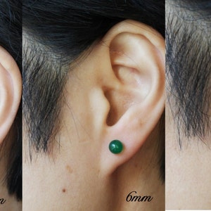 May include: Three close-up images of a person's ear with a green gemstone earring. The earrings are shown in three sizes: 4mm, 6mm, and 8mm.