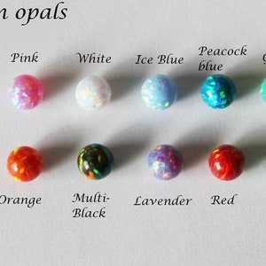 May include: Eight 8mm opal beads in various colors, including pink, white, ice blue, peacock blue, green, orange, multi-black, lavender, and red.