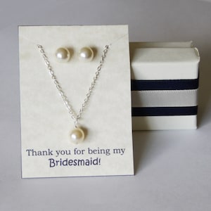 May include: A white card with a silver necklace and pearl earrings. The card says "Thank you for being my Bridesmaid!"