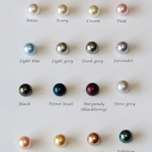 May include: A chart showing 16 different colors of pearls. The pearls are arranged in four rows of four. The colors are: white, ivory, cream, pink, light blue, light grey, dark grey, lavender, black, petrol (teal), burgundy (blackberry), dove grey, peach, gold, rose gold, and Tahitian.