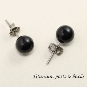 May include: A pair of black onyx stud earrings with titanium posts and backs.