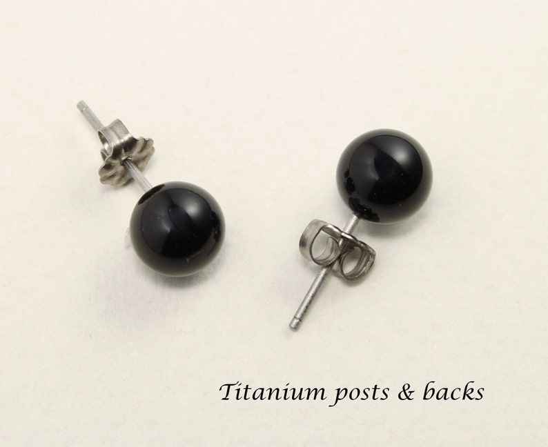 May include: A pair of black onyx stud earrings with titanium posts and backs.