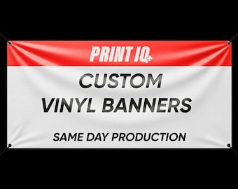May include: A white vinyl banner with a red top section. The banner features the text "PRINT IQ+", "CUSTOM VINYL BANNERS", and "SAME DAY PRODUCTION" in bold, black lettering. Grommets are visible in each corner.
