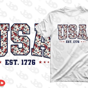 May include: White t-shirt with the word "USA" in a floral pattern, outlined in navy blue, and the text "EST. 1776" below. The floral pattern features red roses on a cream background. The design is repeated on a separate graphic.