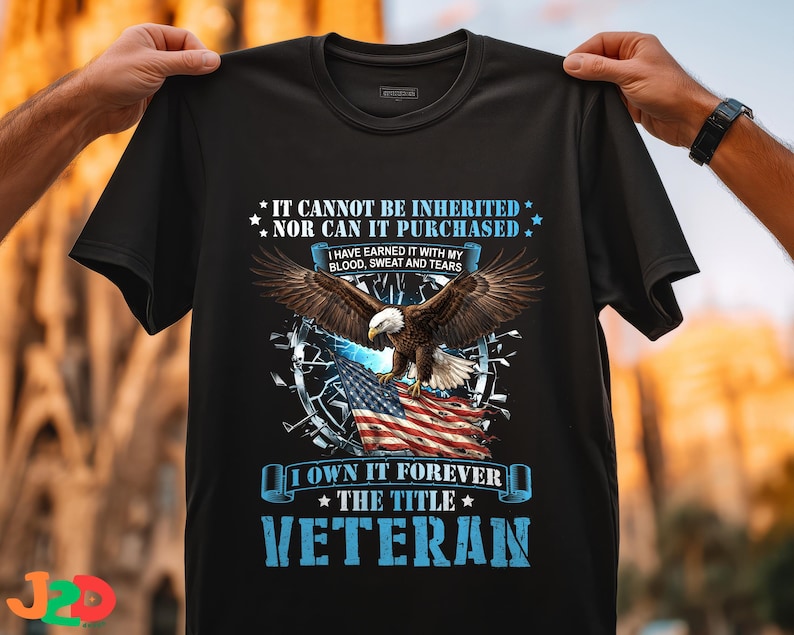 May include: Black t-shirt featuring a majestic bald eagle with outstretched wings, perched above an American flag. The shirt includes the text "IT CANNOT BE INHERITED NOR CAN IT PURCHASED" and "VETERAN".