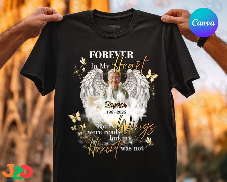 May include: Black t-shirt with a memorial design. The design includes a photo of a woman with angel wings, butterflies, and the text "FOREVER In My Heart". The shirt also includes the name "Sophia 1967-2026" and the words "Your wings were ready but my heart was not."