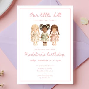 May include: A birthday invitation with the text "Our little doll is turning three" and "Madeline's birthday". The invitation features illustrations of three dolls in dresses. The invitation is on a pink background with a purple envelope.