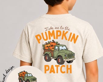 May include: A natural-colored t-shirt featuring a graphic of a green pickup truck carrying pumpkins. The text reads "Take me to the PUMPKIN PATCH" on the back and "MICHAEL" on the front design. The shirt is worn with a navy blue baseball cap.