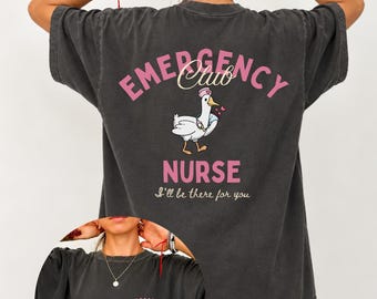 May include: A charcoal gray t-shirt featuring a back graphic of a goose dressed as a nurse with the text EMERGENCY CLUB NURSE and I'll be there for you. The front chest area displays the text ER NURSE CLUB est. 2026 in pink lettering.