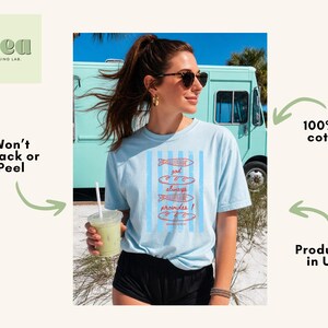 Woman wearing oversized Comfort Colors Christians shirt featuring God Always Provides graphic with fish illustrations and Matthew 14:13-21 Bible verse in vintage aesthetic style.