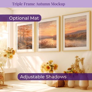 May include: A triple frame autumn mockup featuring three light wood frames hanging on a wall, each displaying a landscape painting of a sunset over a lake with trees. The image includes text overlays reading Triple Frame Autumn Mockup, Optional Mat, and Adjustable Shadows.