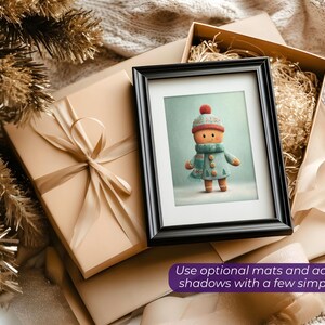 May include: A framed print of a gingerbread person wearing a hat, scarf, and coat. The print is in a black frame, resting on a wrapped gift box with a ribbon. The image is surrounded by other gift boxes and decorative elements. Text: Use optional mats and adjustable shadows with a few simple clicks.