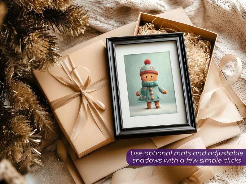 May include: A framed print of a gingerbread person wearing a hat, scarf, and coat. The print is in a black frame, resting on a wrapped gift box with a ribbon. The image is surrounded by other gift boxes and decorative elements. Text: Use optional mats and adjustable shadows with a few simple clicks.