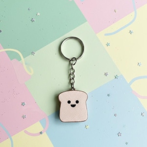 Schattige toastsleutelhanger met billen - uv-harsbedel