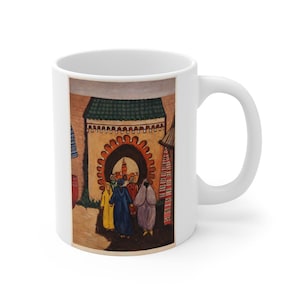 May include: White ceramic mug featuring a colorful illustration of a Middle Eastern market scene. The artwork depicts figures in robes, a decorative archway, and market stalls. The mug has a curved handle.