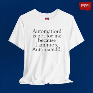May include: White t-shirt with the text "Automation! is not for me because I am more Automated!!!" in black. The shirt has a crew neck and short sleeves. The brand logo is visible on the shirt and in the upper right corner.