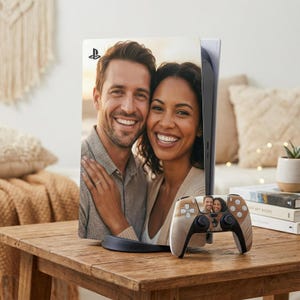 May include: A custom PlayStation 5 console and controller featuring a photograph of a smiling couple. The console is white and black, with the couple's image on the faceplate. The controller has a matching design with the couple's photo.