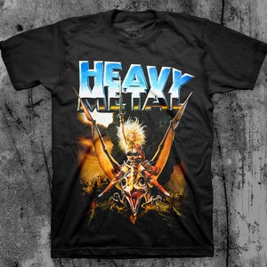 May include: Black t-shirt with a graphic print of a woman riding a winged creature. The text "Heavy Metal" is printed in blue and white letters on the shirt.