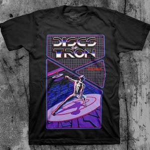 May include: Black t-shirt with a graphic of a video game called "Discs of Tron" featuring a character on a light-up disc. The game is by Atari, Midway.