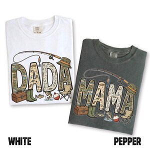 May include: Two t-shirts, one white and one pepper-colored, with fishing-themed designs. The word "DADA" is on the white shirt, and "MAMA" is on the pepper shirt. Each word is filled with fishing-related illustrations.
