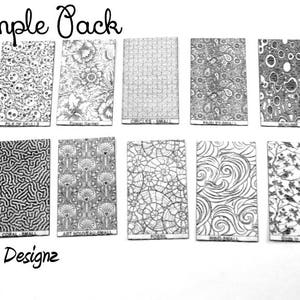 May include: A sample pack of 10 different metal designs. The designs include a pile of skulls, a floral garden, a checkerboard, a path by a small stream, a swirl, a fossil, a coral reef, a stylized art nouveau design, a starburst, and a forest.