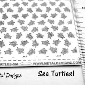 May include: A sheet of white paper with a repeating pattern of small, gray sea turtles. The sheet is labeled "3X4-TURTLES-SM" and "WWW.METALDESIGNZ.COM". The text "Sea Turtles!" is written below the sheet. A ruler is visible on the right side of the image.