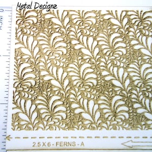 May include: A sheet of laser-cut wood with a repeating pattern of fern-like designs. The sheet measures 2.5 inches by 6 inches and is labeled "2.5 X 6 - FERNS - A".