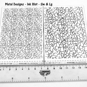 May include: Two sheets of white paper with black ink blot patterns. The sheets are labeled "3X4-INK BLOT-SM" and "3X4-INK BLOT-LG". A ruler is below the sheets, showing measurements in inches and centimeters.