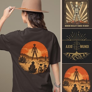 May include: A dark brown t-shirt featuring a graphic print of a desert landscape with a large standing figure, a person sitting, and a bicycle under an orange sun. The design includes the text Black Rock City, Where Reality Goes To Rest, and Axis Mundi.
