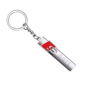 May include: Silver metal keychain with a rectangular pendant. The pendant has a red accent and the letters "S" and "port" in silver. The keychain includes a chain and a circular key ring.