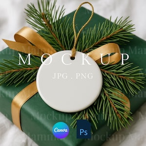 May include: A white, round ornament with a gold string, resting on a green gift box with a gold ribbon and pine branches. The word "MOCKUP" is printed on the top of the ornament. The text "JPG, PNG" is printed on the ornament.