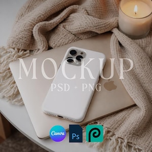 May include: A white smartphone case rests on a closed laptop, with the word "MOCKUP" and "PSD + PNG" overlaid. A lit candle and a beige knitted blanket are in the background. The image also includes the logos for Canva, Photoshop, and Procreate.