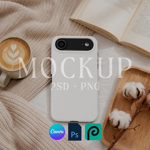 May include: A white phone case mockup with a black camera section, resting on a beige surface. A cup of latte art, an open book, and a wooden tray with cotton stems are also present. The word "MOCKUP" is overlaid on the image, along with "PSD + PNG".