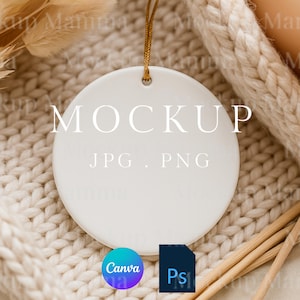 May include: A white, round ceramic ornament with the word "MOCKUP" in the center. The text "JPG . PNG" is below. A gold string is attached for hanging. The ornament is on a cream-colored knitted surface. A Canva and Photoshop logo are at the bottom.