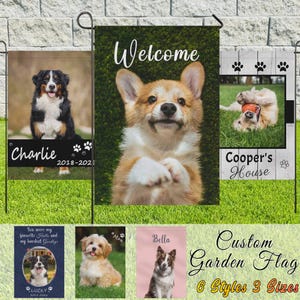May include: A collection of custom garden flags featuring dog portraits. The flags display various dog breeds with names and dates, including a Bernese Mountain Dog, a Corgi, and a Border Collie. The flags are in different styles and sizes.