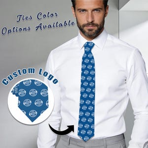 May include: A blue tie with a repeating white logo pattern. The tie is worn with a white dress shirt. Text on the image reads "Ties Color Options Available" and "Custom Logo".