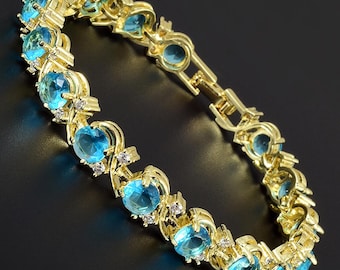 RIZILIA BLOSSOM March Birthstone Tennis Bracelet • Aquamarine Blue CZ • 18K Gold/White Gold • 7"