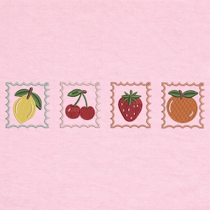 May include: Embroidered fruit designs including a lemon, cherries, a strawberry, and an orange, each within a decorative square frame. The fruits are in their natural colors, with green leaves, on a light pink background.