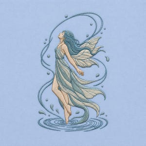 May include: Embroidered image of a fairy with flowing blue hair and a light blue dress, standing in water. The fairy has detailed wings and is surrounded by water droplets and swirling lines, all on a light blue background.