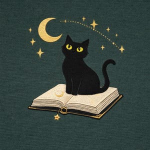 May include: Embroidered design featuring a black cat with yellow eyes sitting on an open book. A gold crescent moon and stars are in the background. The design is on a dark teal background.