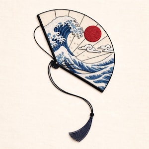 May include: Embroidered fan with a Japanese wave design, a red sun, blue waves, and white clouds. It has a black handle and a blue tassel. The fan is a decorative item.