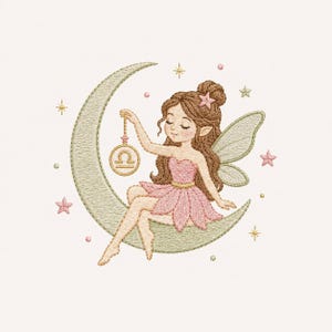 May include: An embroidery design featuring a fairy with brown hair in a bun, wearing a pink dress and wings, sitting on a light green crescent moon. The fairy holds a gold circular charm with the Libra zodiac symbol, surrounded by small stars.