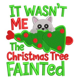 May include: A whimsical Christmas-themed design featuring a gray cat peeking over a green Christmas tree decorated with red ornaments. The text reads "IT WASN'T ME The Christmas Tree FAINTED" in red and green lettering, perfect for holiday decor.