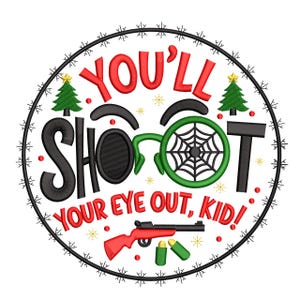 May include: A circular design with the text "YOU'LL SHOOT YOUR EYE OUT, KID!" in red and black. The design includes a red rifle, green bullets, and a green spiderweb. Two green Christmas trees and snowflakes complete the design.