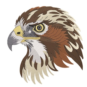 May include: Embroidered image of a hawk's head in profile. The hawk features detailed stitching in shades of brown, tan, and white, with a yellow eye and a gray beak. The design is set against a white background.