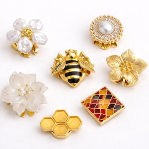 May include: A set of three ceramic mugs with a speckled, matte finish. The mugs are in shades of cream, light gray, and dark gray. Each mug has a simple, minimalist design, perfect for coffee or tea.