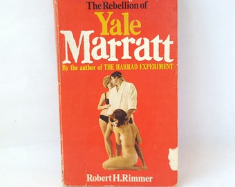May include: A red paperback book with the title "The Rebellion of Yale Marratt" by the author of "The Harrad Experiment". The cover features a photo of three people, two women and one man.