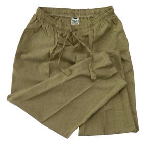 May include: Olive green trousers with an elasticated waistband and drawstring. The trousers are made of a lightweight fabric and have a relaxed fit. A small tag is visible on the waistband. Suitable for casual wear.